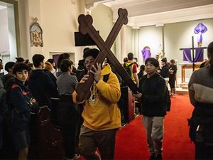 Parramatta Marist Westmead students carrying the carrying the processional cross to St Patrick's Cathedral, Parramatta.