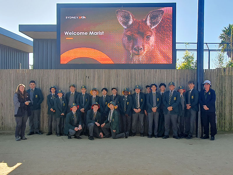 Parramatta Marist Westmead students posing under a Welcome sign at Sydney Zoo