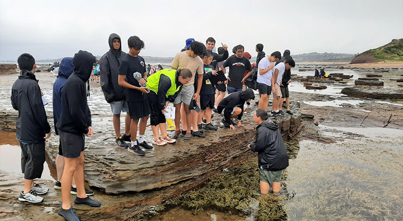 Students from Parramatta Marist High School Westmead on an excursion by the ocean