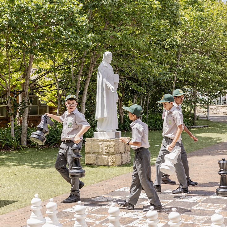 Students playing outdoor chess at Parramatta Marist High School Westmead